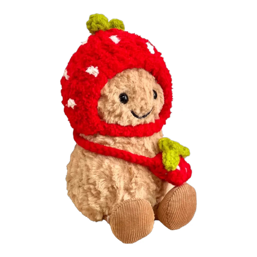 Jellycat Amuseables Peanut keychain wearing a red strawberry-themed head cover and holding a matching small bag.