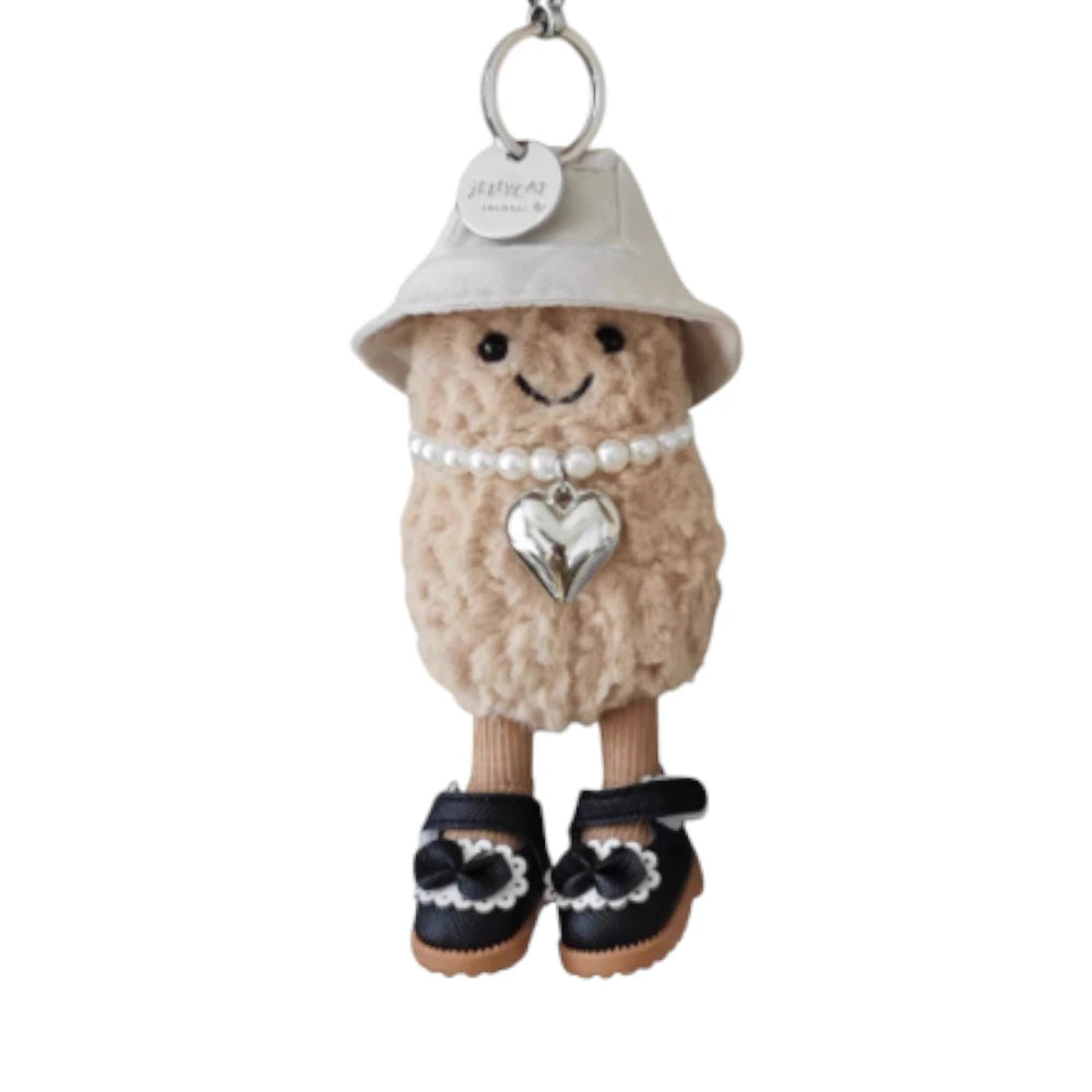 Jellycat Amuseables Peanut keychain dressed in a 3-piece princess set, featuring a crown, necklace, and shoes.