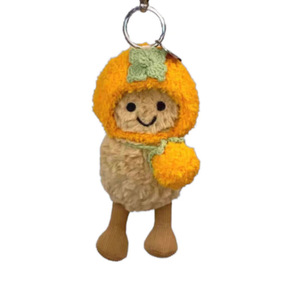 Jellycat Amuseables Peanut keychain wearing a persimmon-themed head cover and holding a matching small bag.