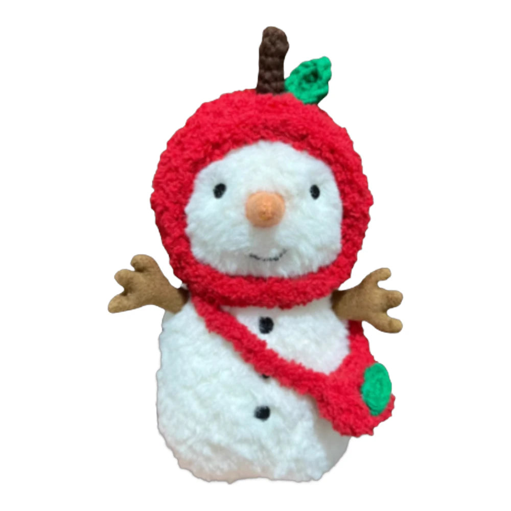 Jellycat Little Snowman plush wearing an apple-themed head cover and holding a matching small bag.