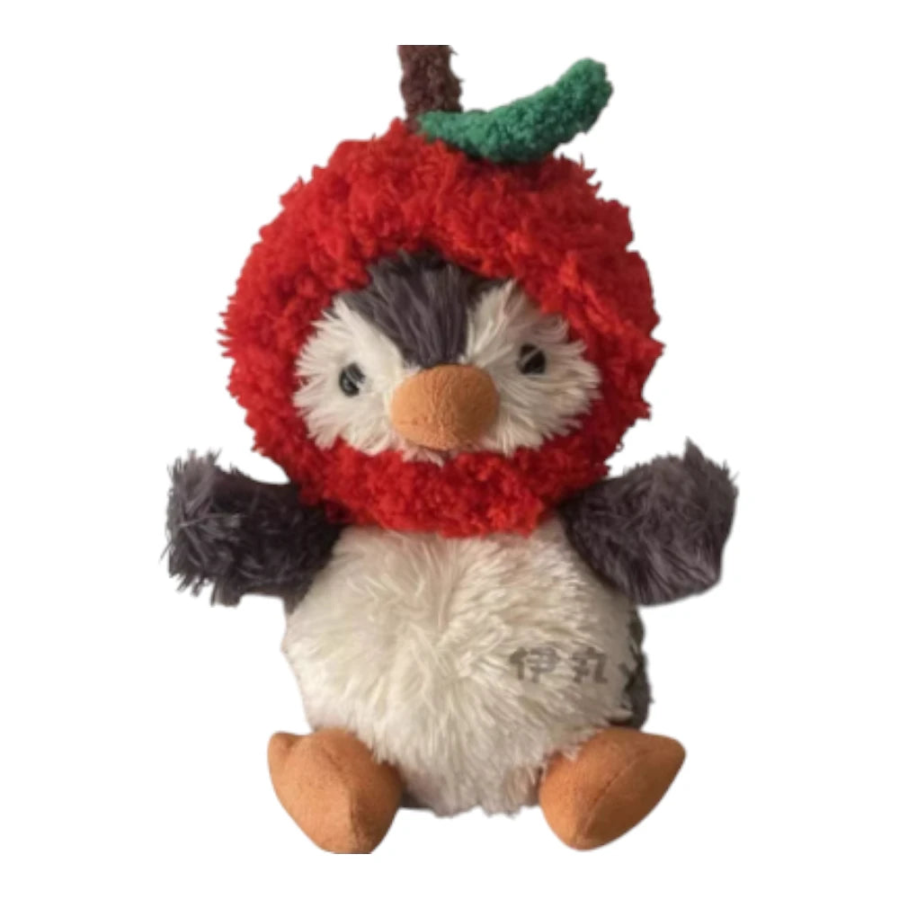 Jellycat Peanut Penguin Bag Charm wearing an apple-themed head cover.