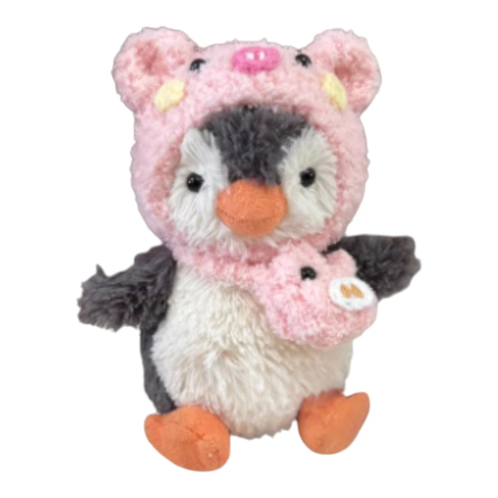 Jellycat Peanut Penguin Bag Charm wearing a pig-themed head cover and holding a matching small bag.