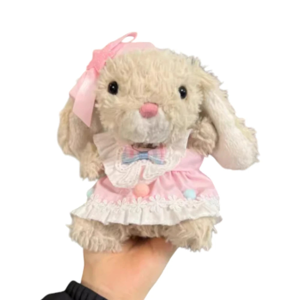 Jellycat Yummy Bunny plush wearing a pink skirt dress and a matching pink bow headband.