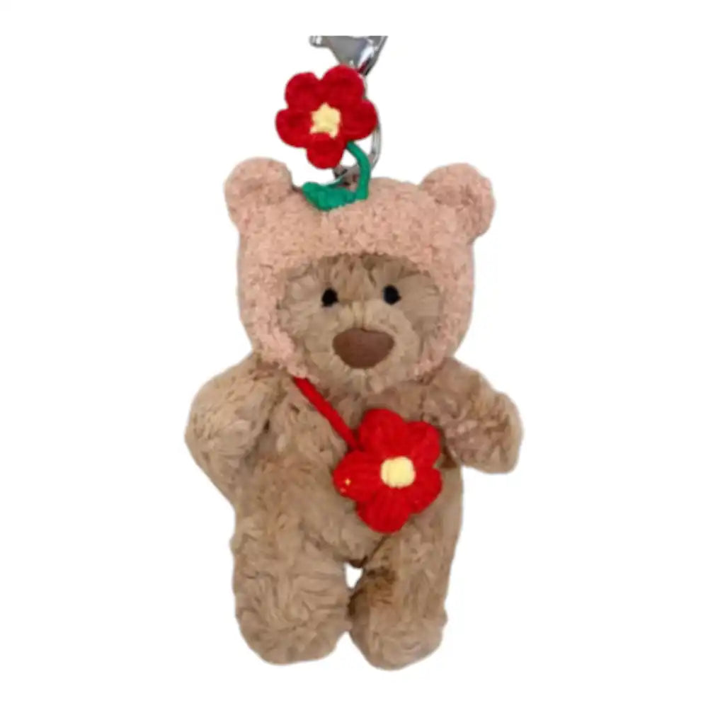 Jellycat Bartholomew Bear Bag Charm wearing a vibrant Flower headcover and holding a small matching bag.