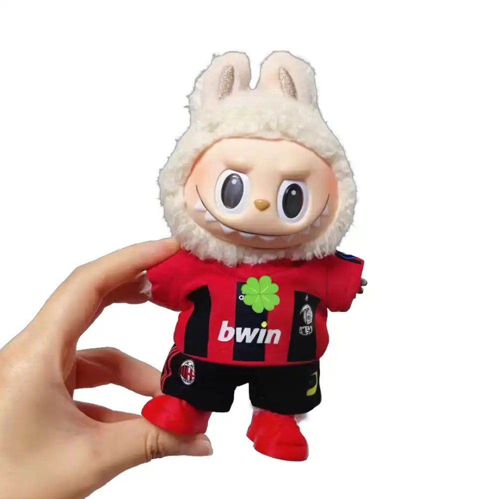 Labubu plush toy wearing a custom AC Milan Football Club jersey outfit with a chosen number, including a red and black striped replica jersey and matching shorts.