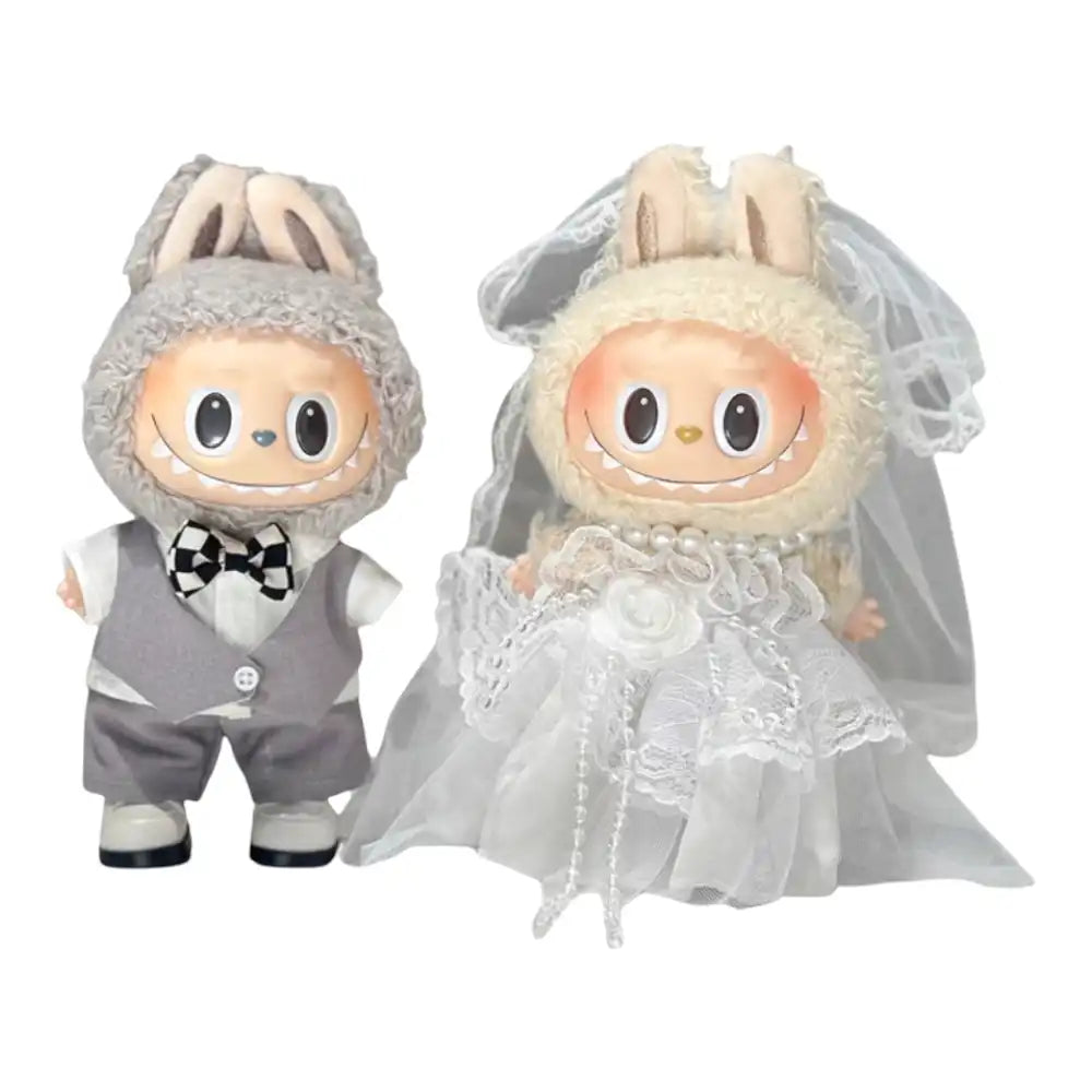 Labubu plush toy wearing a bridal outfit. One option shows a male-style outfit with a waistcoat, shirt, bow tie, pants, and shoes. The other option shows a female-style outfit with a lace skirt dress, hair accessory, necklace, and shoes.
