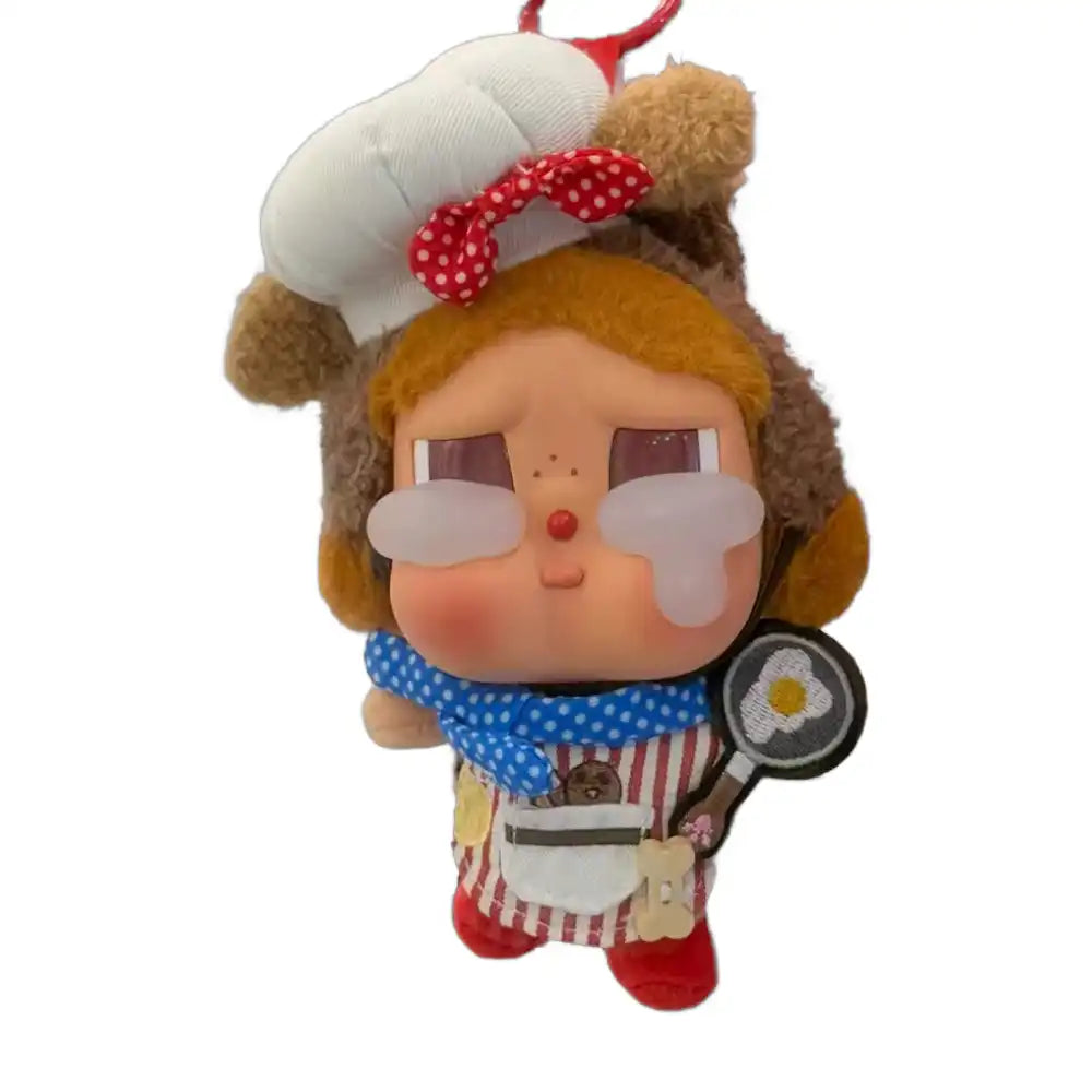 Crybaby figure wearing a 4-piece Chef Outfit, including a chef coat, tall chef hat, kitchen utensil accessory, and scarf/bandana.