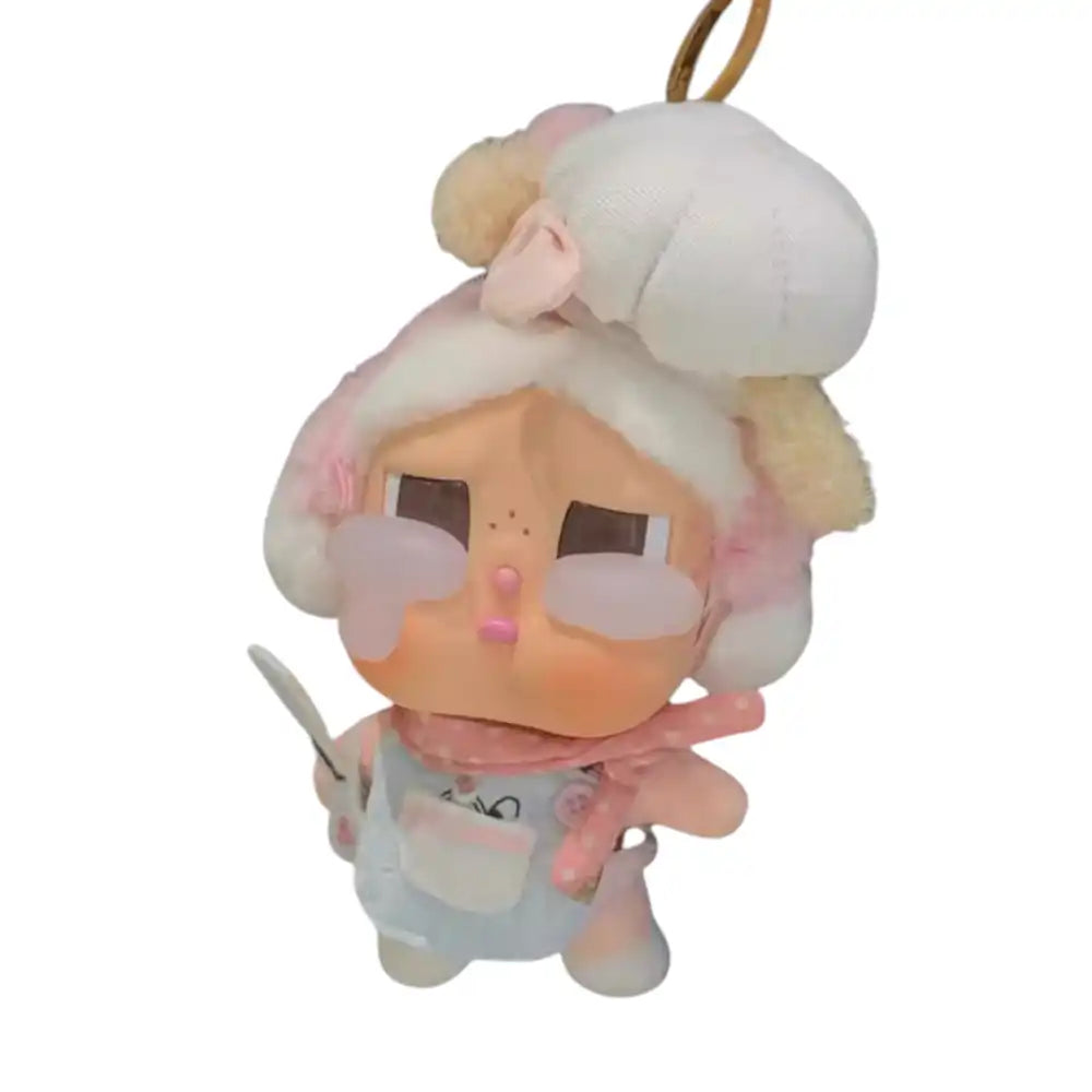 Crybaby figure wearing a 4-piece Kitchen Helper Outfit, including an apron dress, hat, kitchen utensil accessory, and scarf/bandana.