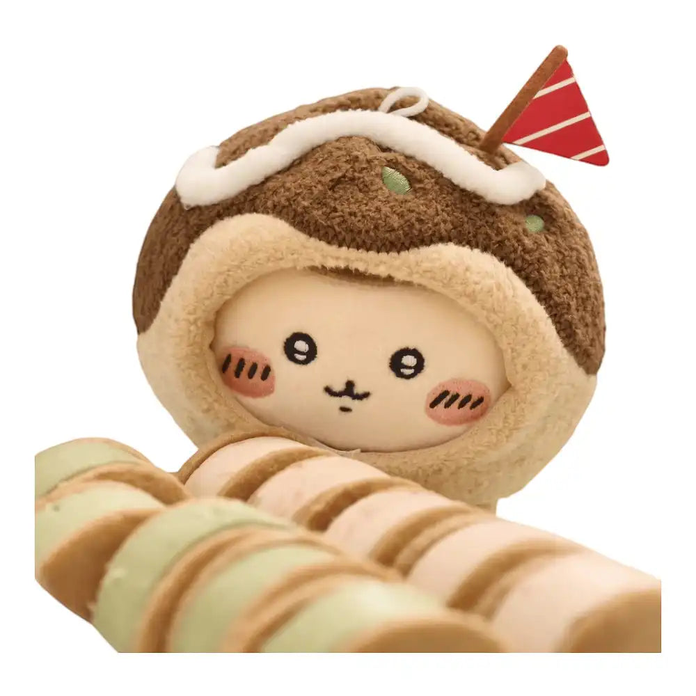 Chiikawa 10cm plush toy wearing a brown takoyaki-shaped head cover accessory with green and red toppings.