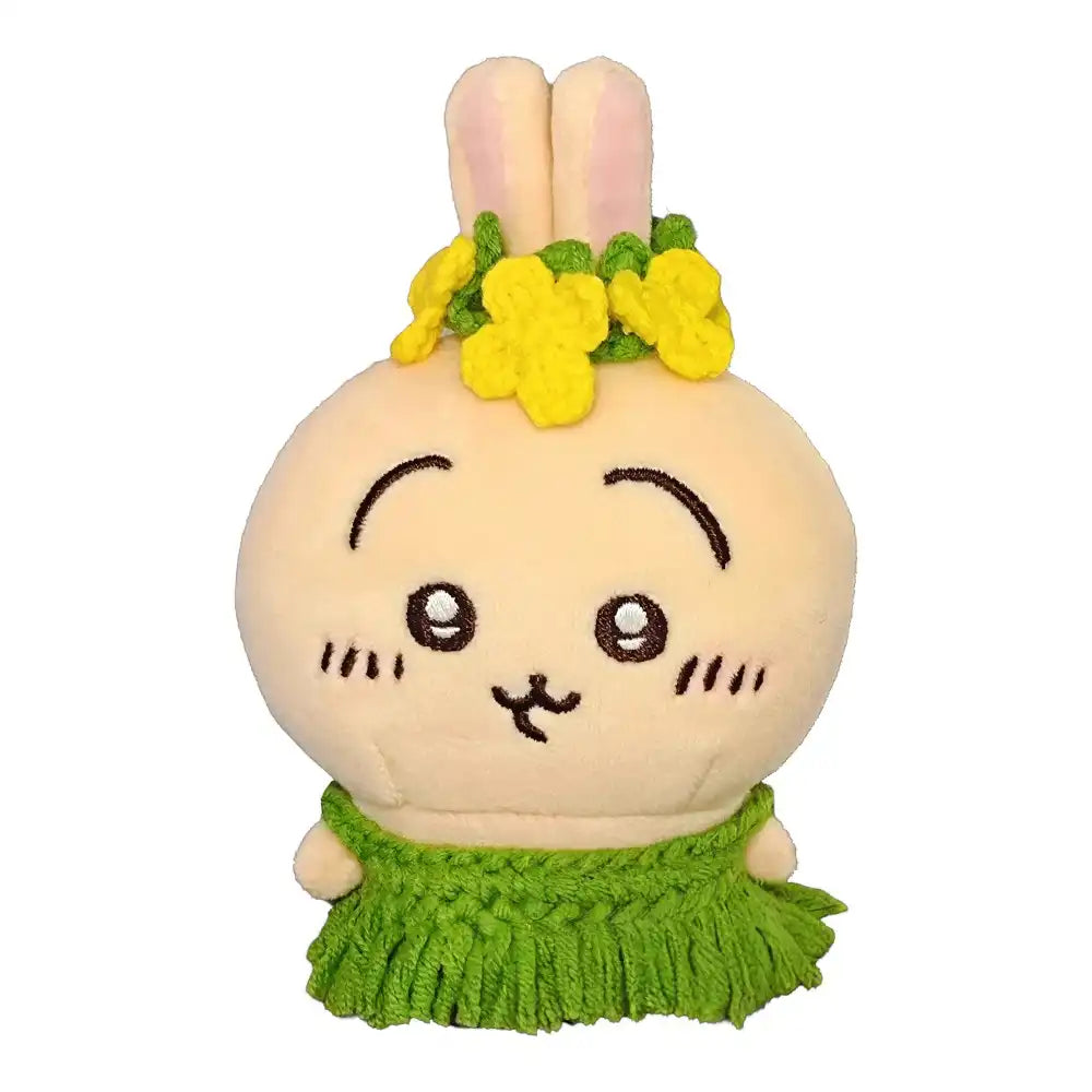 Chiikawa 10cm plush toy wearing a green grass skirt and a colorful flower lei (e.g., yellow, pink, blue, or purple).