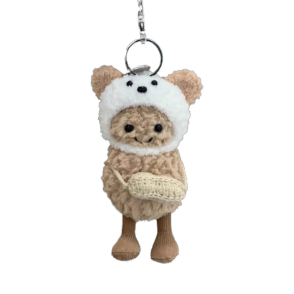 Jellycat Amuseables Peanut keychain wearing a dog-themed head cover and holding a matching small bag.