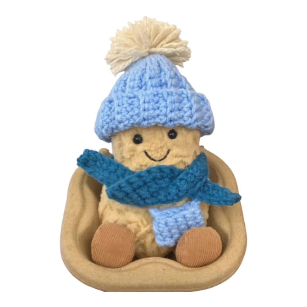 Jellycat Amuseables Peanut keychain wearing a blue bobble hat head cover, a matching blue scarf, and holding a matching small blue bag.