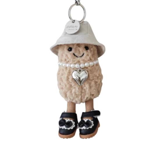 Jellycat Amuseables Peanut keychain dressed in a 3-piece princess set, featuring a crown, necklace, and shoes.