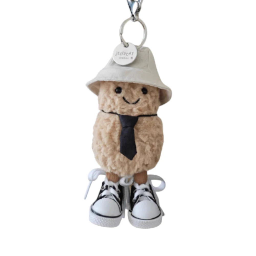 Jellycat Amuseables Peanut keychain dressed in a 3-piece office worker set, featuring a hat, tie, and shoes.