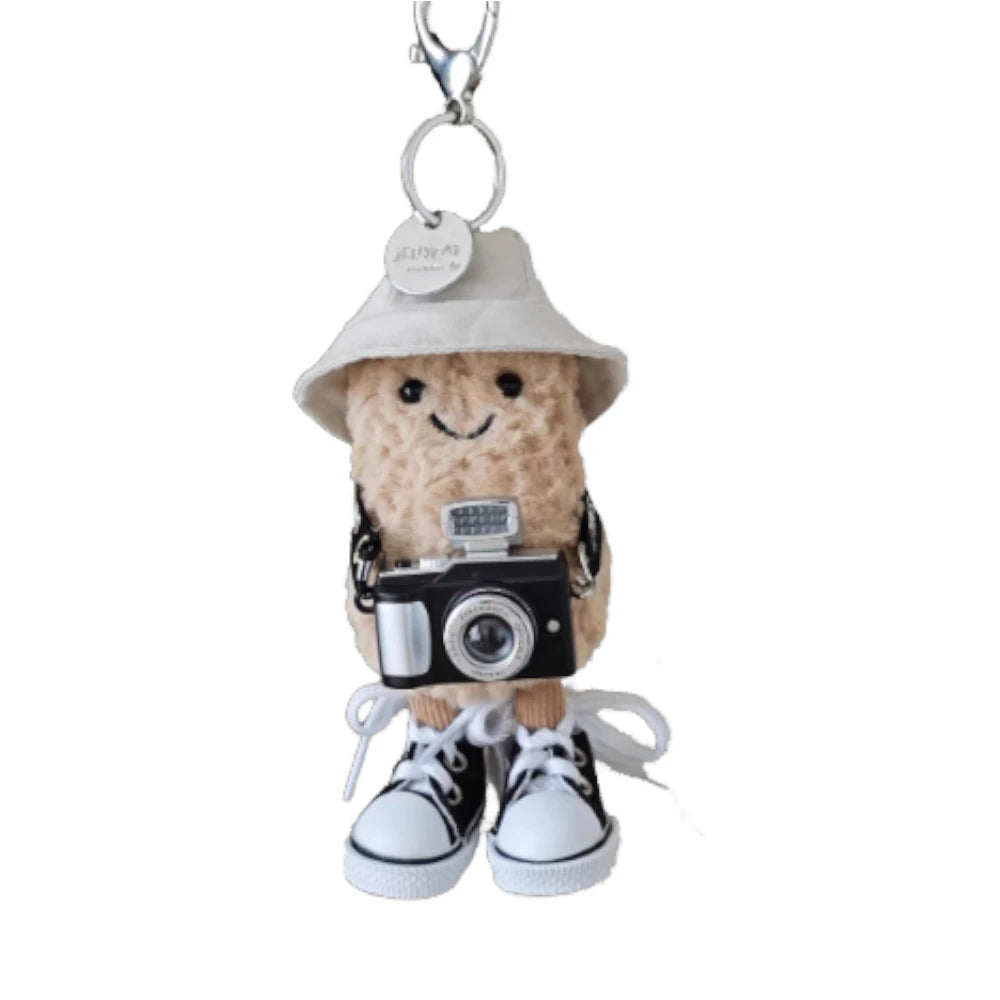 Jellycat Amuseables Peanut keychain dressed in a fisherman outfit, featuring a hat and fishing-themed attire.
