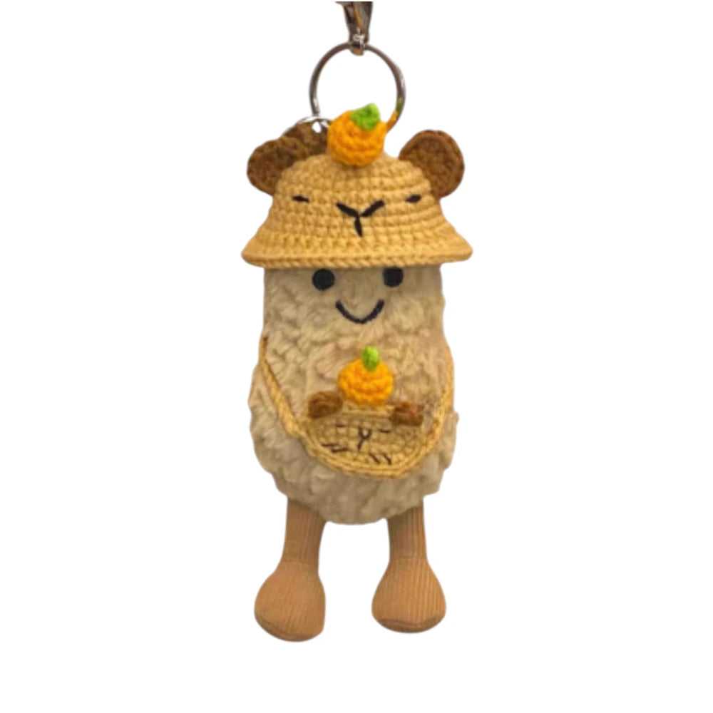 Jellycat Amuseables Peanut keychain wearing a bear hat head cover and holding a matching small bag.