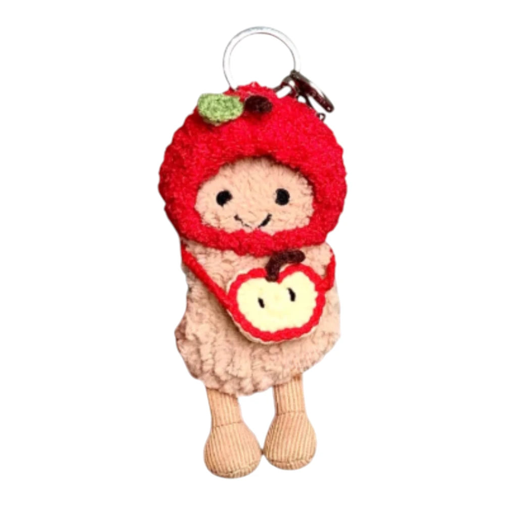 Jellycat Amuseables Peanut keychain wearing an apple-themed head cover and holding a matching small bag.