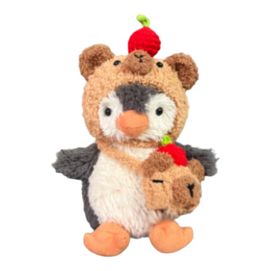 Jellycat Peanut Penguin Bag Charm wearing a capybara-themed head cover and holding a matching small bag.