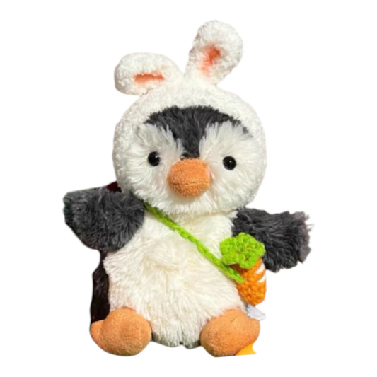 Jellycat Peanut Penguin Bag Charm wearing a rabbit-themed head cover and holding a matching small bag.