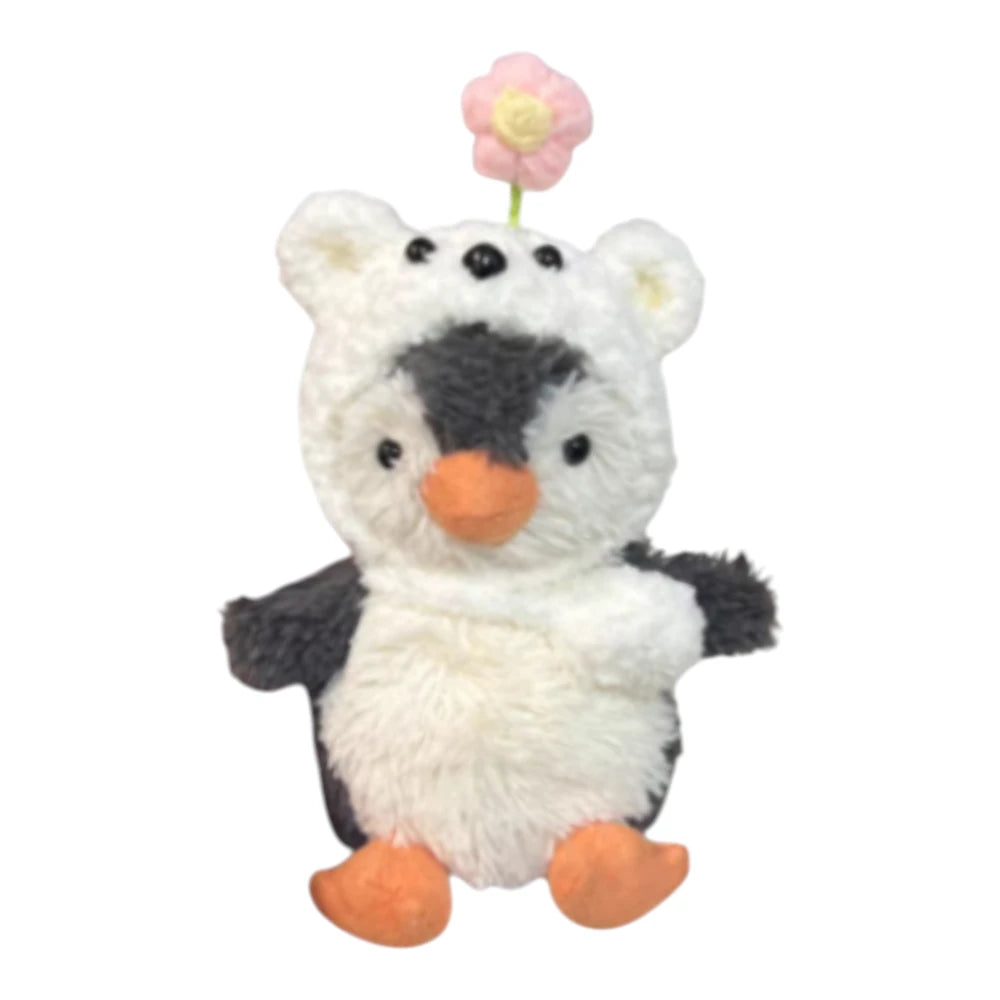 Jellycat Peanut Penguin Bag Charm wearing a polar bear-themed head cover and holding a matching small bag.