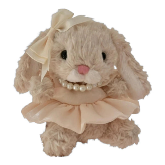 Jellycat Yummy Bunny plush wearing a pink dress, a pearl necklace, and a matching bow headband.
