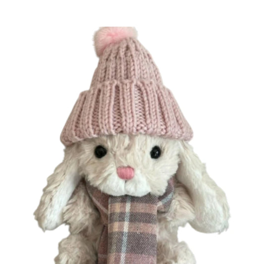 Jellycat Yummy Bunny plush wearing a pink bobble hat and a matching plaid scarf.