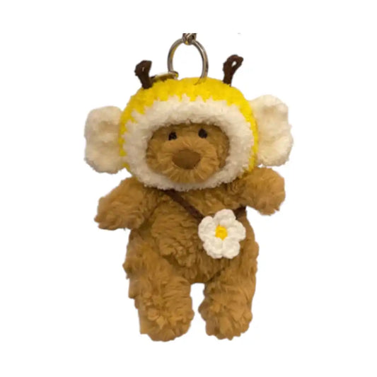 Jellycat Bartholomew Bear Bag Charm adorned with a Little Bee headcover and a small matching bag.
