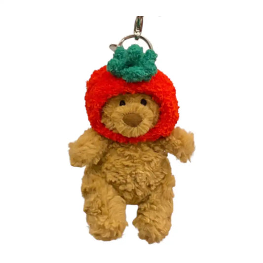 Jellycat Bartholomew Bear Bag Charm wearing a bright red Apple headcover.