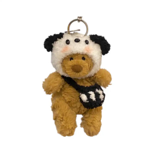 Jellycat Bartholomew Bear Bag Charm dressed in a Dog headcover with floppy ears and holding a small matching bag.
