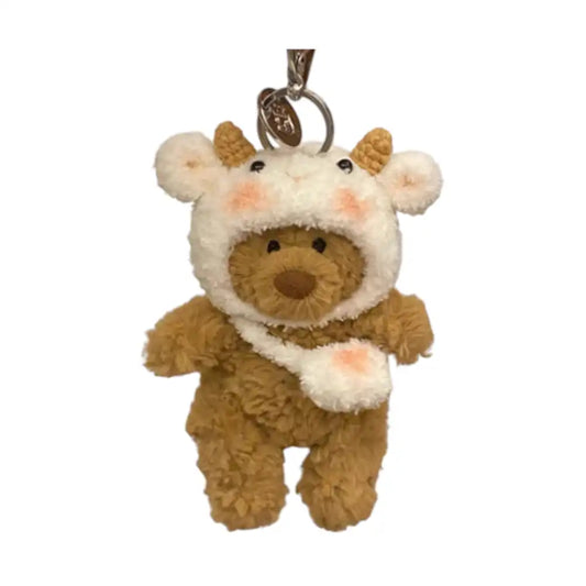 Jellycat Bartholomew Bear Bag Charm wearing a Goat headcover with horns and holding a small matching bag.