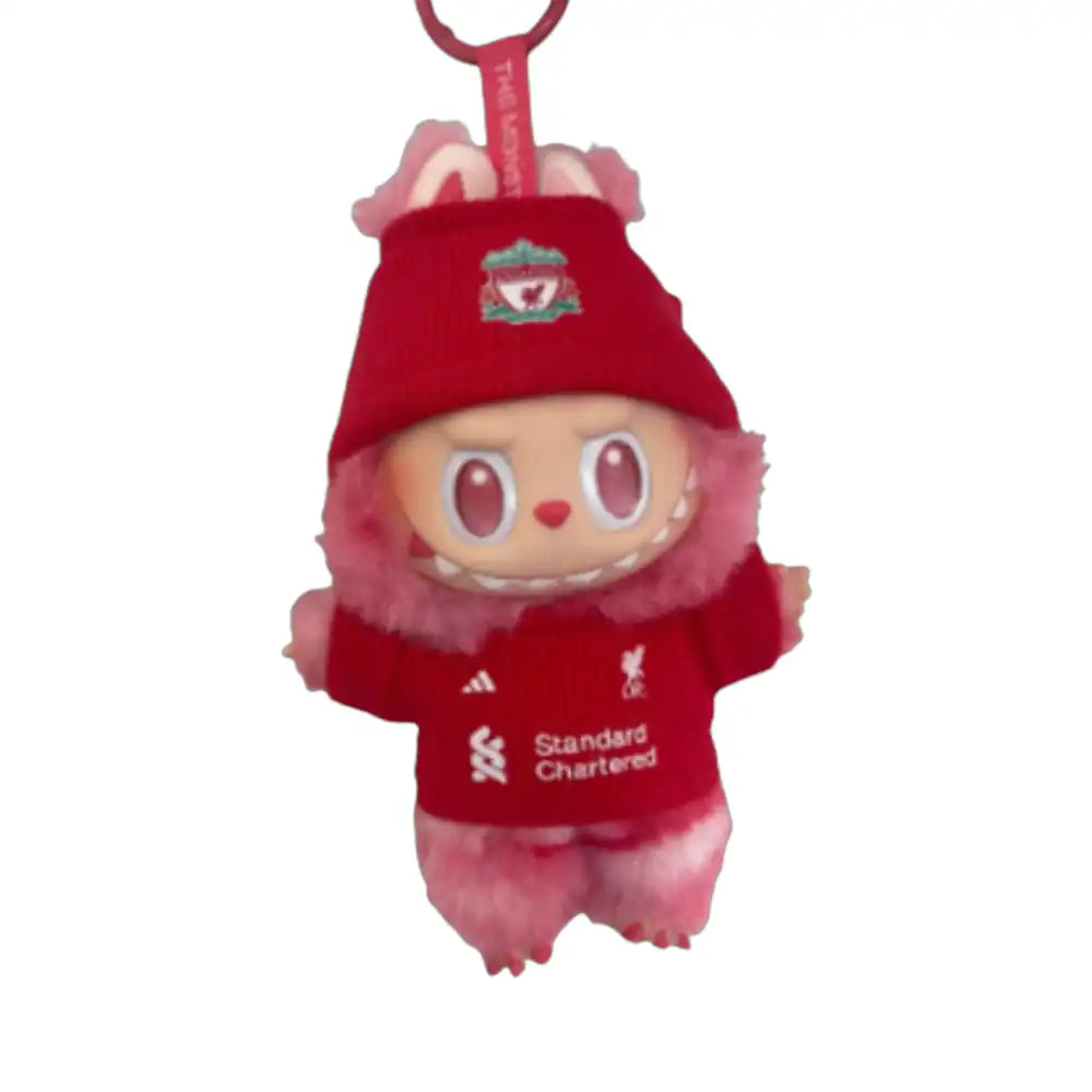 Labubu plush toy wearing a custom Liverpool Football Club jersey outfit with a chosen player number, including a red replica jersey and a coordinating hat.