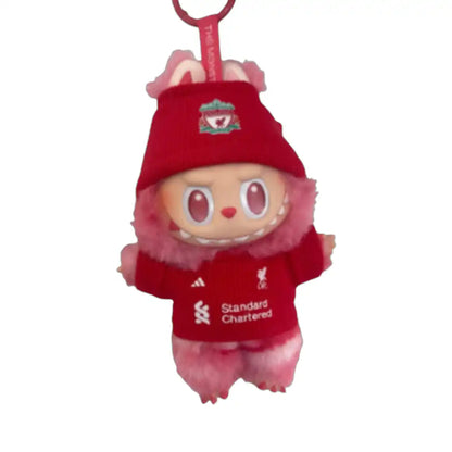 Labubu plush toy wearing a custom Liverpool Football Club jersey outfit with a chosen player number, including a red replica jersey and a coordinating hat.
