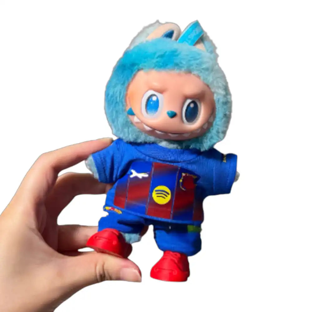 Labubu plush toy wearing a custom Barcelona Football Club jersey outfit with a chosen number, including a blue and garnet striped replica jersey and matching shorts.