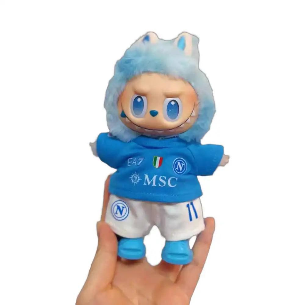 Labubu plush toy wearing the complete SSC Napoli Football Club jersey outfit, featuring a sky blue replica jersey with pre-printed number 11 "De Bruyne", matching shorts, and miniature football shoes.
