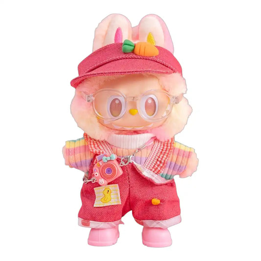 Labubu plush toy wearing a full 6-item Pink Overalls with Rainbow Sweater Outfit, including a hat, rainbow sweater, pink overalls, shoes, glasses, and a miniature camera.