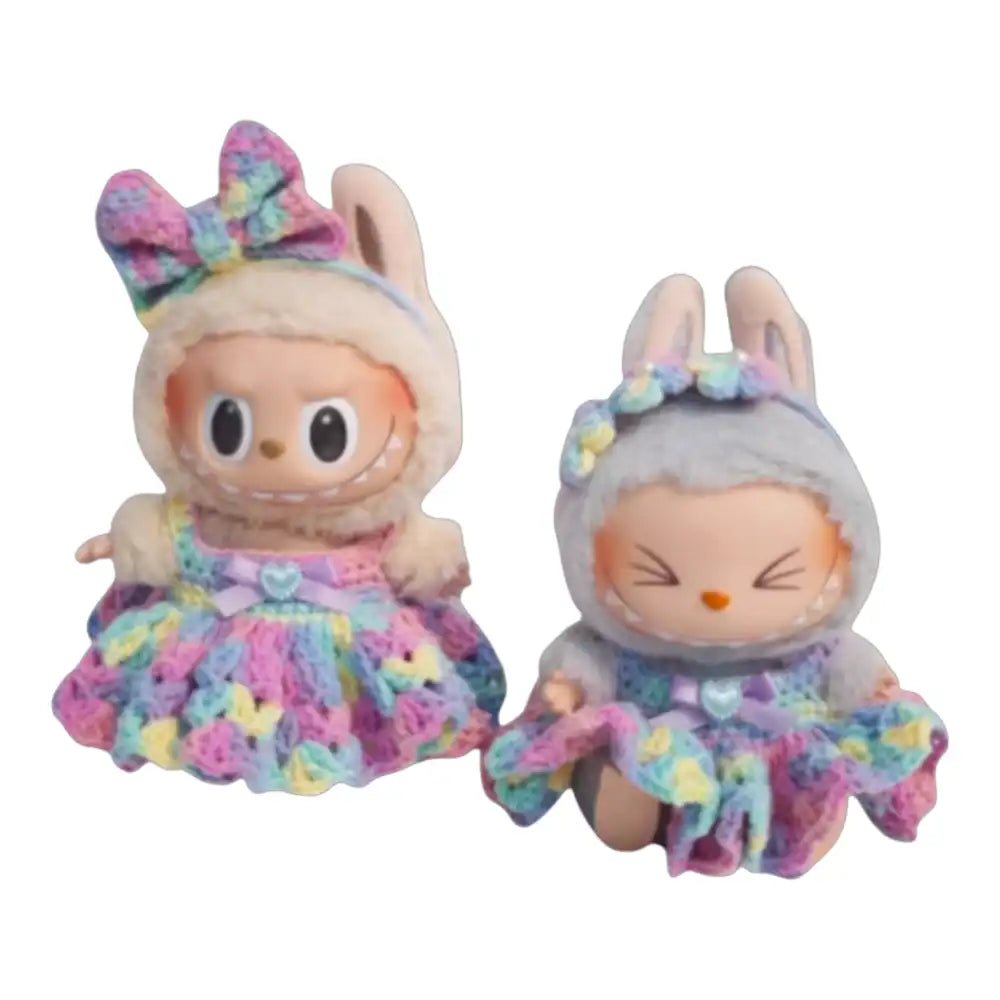 Labubu plush toy wearing a hand-crocheted rainbow dress outfit, complete with a hair accessory, available in bow or flower style.
