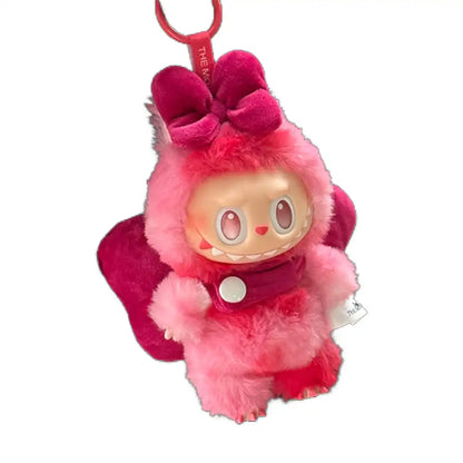 Labubu plush toy wearing a complete butterfly-themed outfit with wings, designed to transform it into a beautiful butterfly, available in pink, rose red, purple, or light blue.