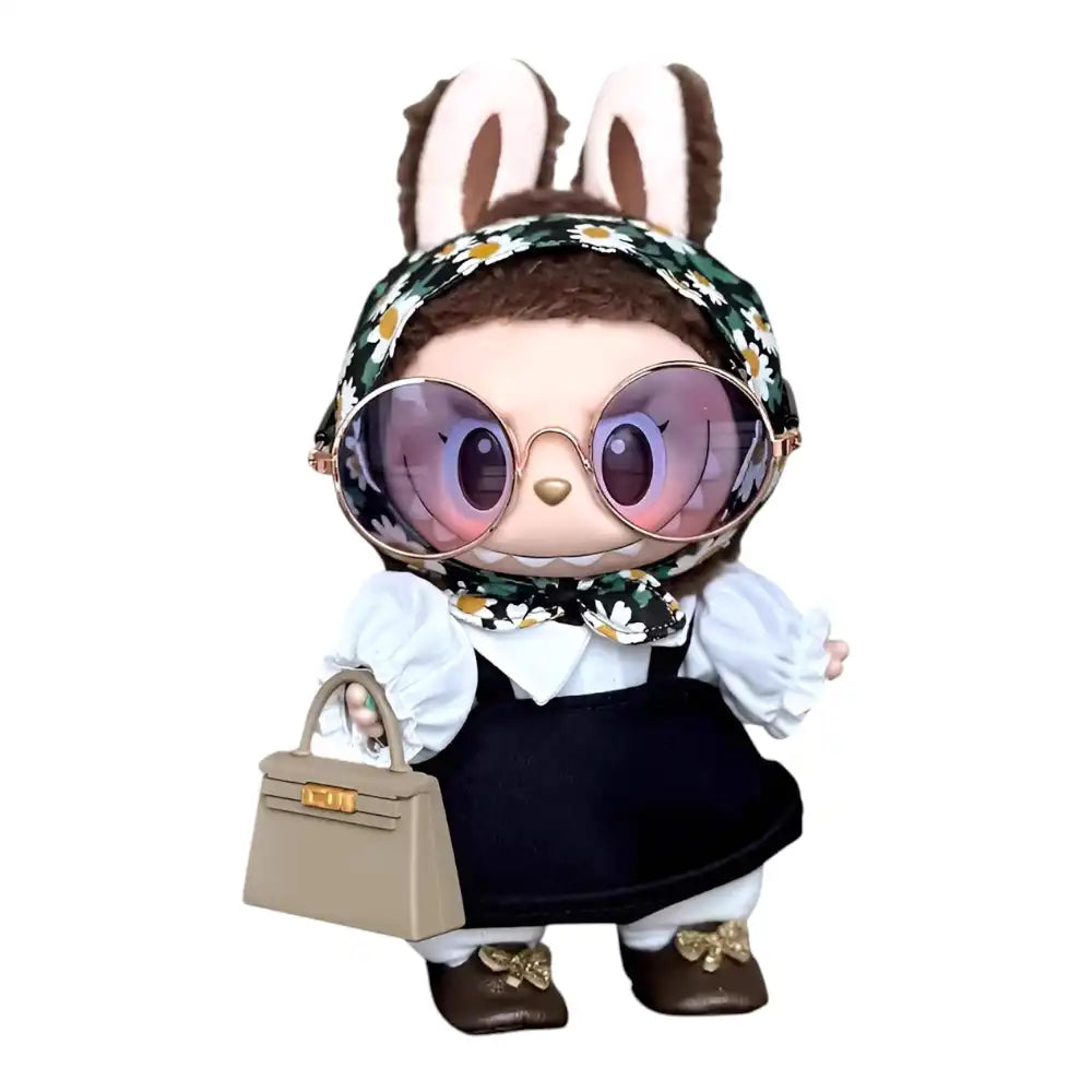 Labubu plush toy wearing a 3-piece outfit, including a black pinafore dress, a white shirt, and a floral headscarf. Handbag and glasses are not included.