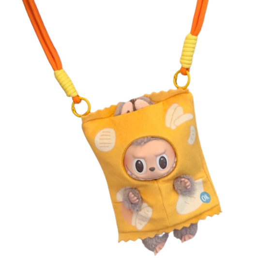 A Labubu figure posing with two miniature potato chip bag accessories, one in yellow and one in orange, both featuring realistic graphics and back straps.